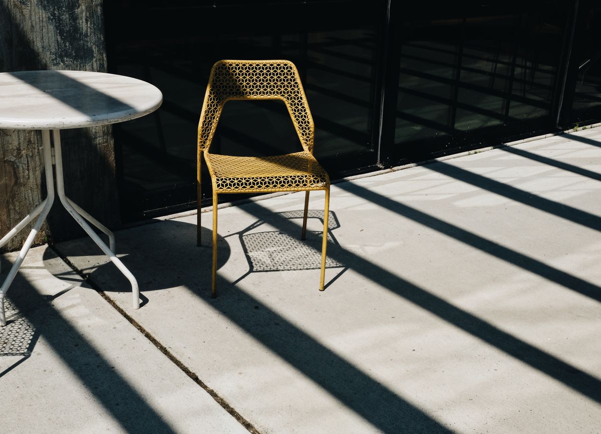 Finished concrete patio with outdoor seating in warm afternoon light